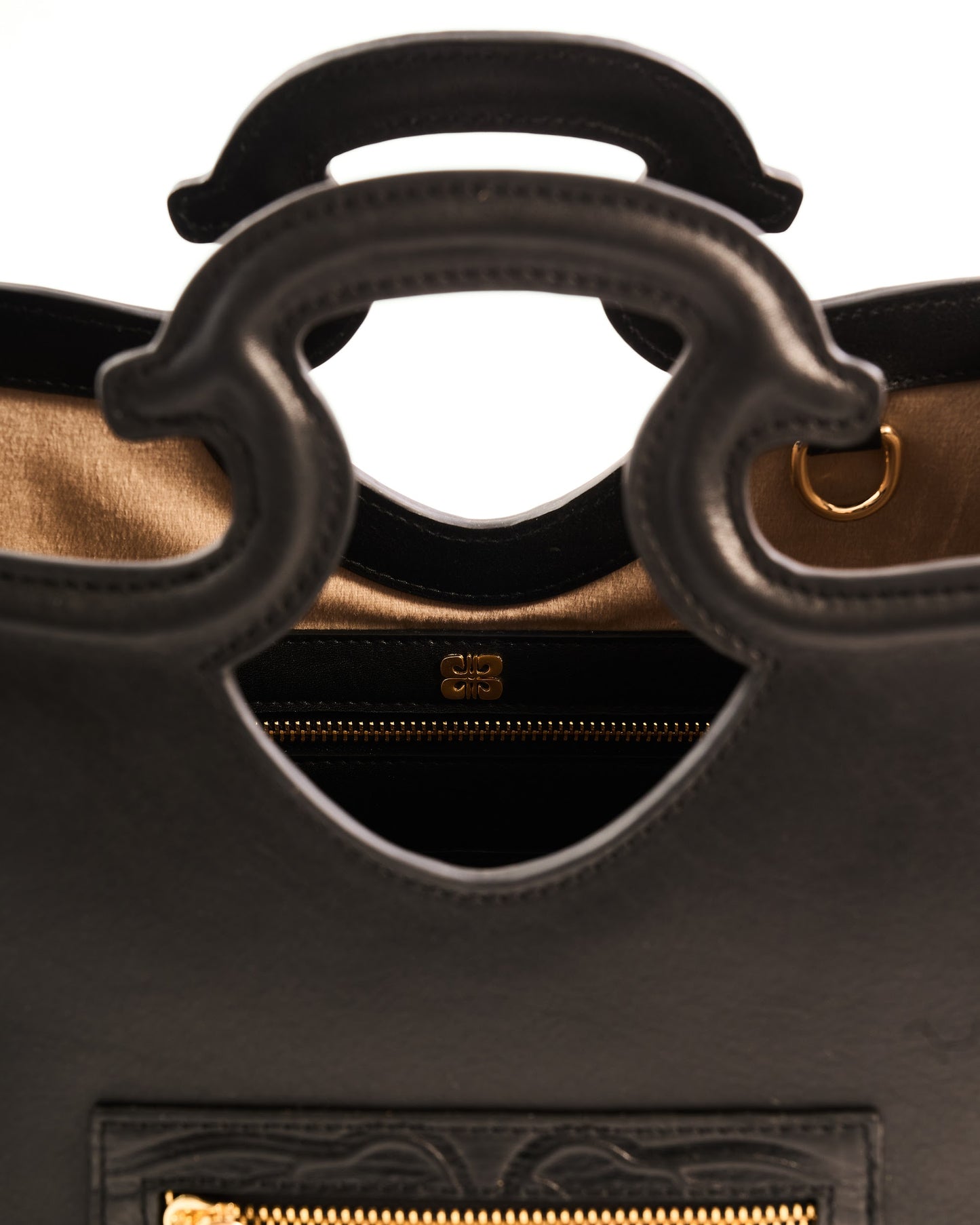 Black handbag with a gold zipper on a white background