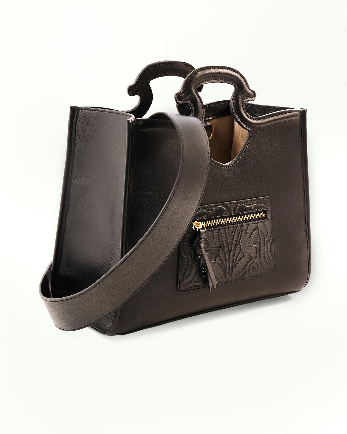 Black handbag with a gold zipper on a white background
