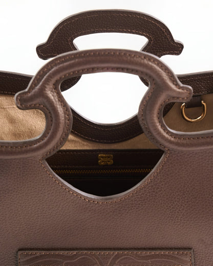 Brown leather handbag with a gold zipper on a white background