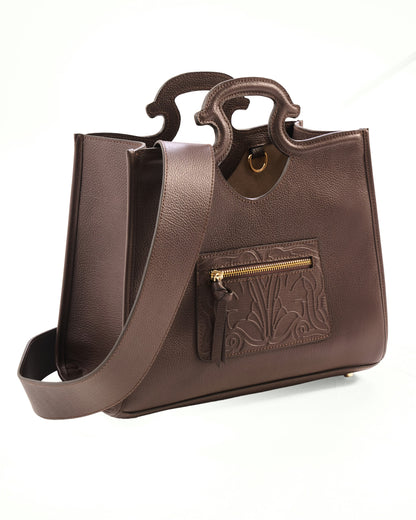 Brown leather handbag with a gold zipper on a white background